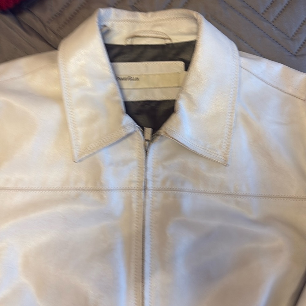 Perry Ellis white leather jacket. Shows signs of wear in some places. Please ask